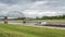 Towboat with barges is passing under a bridge on the Chain of Rocks Canal of Mississippi River