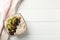 Towel and bowl oatmeal porridge and fruits on wooden background