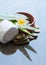 Towel, flowers, green leaves and cosmetics