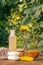 Towel, soap with marigold extract, calendula flowers in a flask with natural background