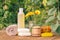 Towel, soap with marigold extract, calendula flowers in a flask with natural background