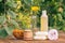 Towel, soap with marigold extract, calendula flowers in a flask with natural background