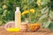 Towel, soap with marigold extract, calendula flowers in a flask with natural background