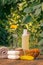 Towel, soap with marigold extract, calendula flowers in a flask with natural background