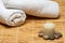 Towels with candle, rocks on bamboo mat