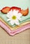 Towels with a daisy and rose petals