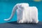 Towels in form of elephants on sunbed at luxury swimming pool