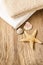 Towels, shells and a starfish on wooden table