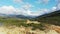 The tower above the Fango Delta pebble beach amidst mountains and green countryside