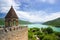 Tower of Ananuri Castle with Church and fortress in Georgia on the blue lake background