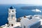 The tower of Anastasi church and a parasol with ocean and islands in the background, Imerovigli, Santorini, Greece