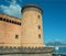 Tower of the ancient Angevin castle of Naples, in the background panoramic view of the Vesuvius volcano, Naples, Italy, september