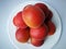 A tower of apricots on the white plate