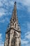 tower bell of the St Etienne protestant temple on blue cloudy sky background in Mulohuse - France