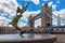 Tower Bridge and the bronze Girl with a Dolphin Fountain Statue, London