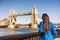Tower Bridge London city travel woman tourist girl at Europe destination landmark famous attraction. Woman traveling in