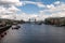 Tower Bridge over the River Thames in London. Buildings on the waterfront and boats on the water.