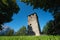 The tower castle ruin of Hoertenberg between evergreen trees and rocky mountainrange, Pfaffenhofen, Tirol, Austria