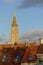 Tower of the church of our Lady above the rooftops of medieval houses in  Bruges,