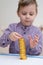 Tower of coins. A little boy builds a column of gold coins