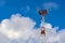 Tower connection with the mast and antennas against the blue sky with clouds. Transmission and reception of signals.