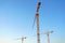 tower crane against blue sky. Image from below.