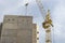 A tower crane assembles gutter panels during the construction of a panel house. Modern housing construction. Industrial