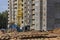 A tower crane assembles gutter panels during the construction of a panel house. Modern housing construction. Industrial