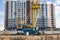 A tower crane assembles gutter panels during the construction of a panel house. Modern housing construction. Industrial