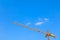 Tower crane high on sky background