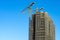 Tower crane scaffolding construction high-rise building blue sky