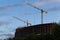 Tower cranes on industrial construction site. New building