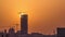 A tower in Doha timelapse, Qatar, under construction, silhouetted against the sunset.