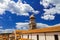 Tower with a dome, roofs of houses against a blue sky with clouds in Croatia