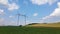 Tower with electric power lines for transfering high voltage electricity located in agricultural cornfield. Delivery of