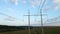 Tower with electric power lines for transfering high voltage electricity located in agricultural cornfield. Delivery of