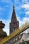 Tower of famous Strasbourg Cathedral in France in romanesque and gothic architecture style with golden fence