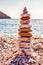 The tower of flat stones on the beach. Stone balancing is the art discipline, or hobby in which rocks naturally balanced on top of