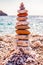 The tower of flat stones on the beach. Stone balancing is the art discipline, or hobby in which rocks naturally balanced on top of