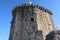 Tower of the Kamerlengo Fortress with the flag of Croatia on the observation deck on a sunny day, Trogir