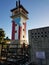 Tower in La Guancha, in Ponce, Puerto Rico with please don`t sit in this area sign in Spanish and Puerto Rico flag