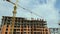 Tower lifting cranes at high residential apartment buildings construction site. Real estate development