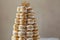 A tower of macaroons adorned with elegant gold decorations on the top, creating a visually appealing and luxurious dessert display