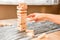 A tower made of Jenga wooden blocks, an arcade social game