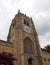 The tower of medieval bradford cathedral in west yorkshire with clock and windows