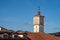 Tower of the old town hall with a clock in Guernica, Basque Country, Spain. Over the roofs view.