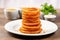 a tower of onion rings on a plain white plate