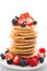 Tower of pancakes with strawberries and honey