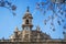 A tower of Saint John`s Two Saint Johns Episcopal Church and tree branches at the foreground