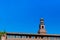 Tower of Sforzesco Castle under blue sky in downtown Milan, Ital